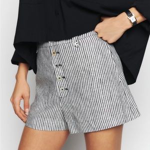 Reformation “Grayson” linen shorts in Vineyard